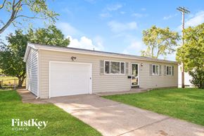 Florissant house for rent - A two-car garage with a FirstKey Homes logo.