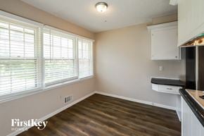 Raytown house for rent - an empty kitchen with wood flooring and a large window