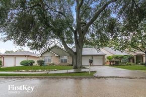 Houston house for rent - A tree in front of a house with the words "FirstKey Homes" on the bottom left.