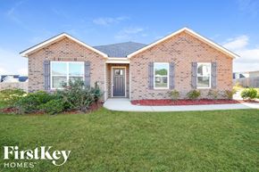 Vance house for rent - a small brick house with a yard and grass