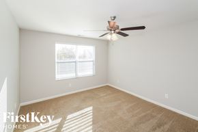 Vance house for rent - a bedroom with a ceiling fan and a window