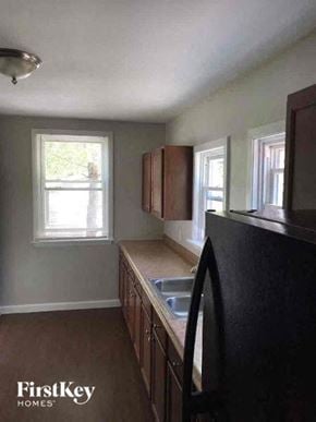 Aurora house for rent - a kitchen with a sink and cabinets and a window