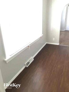 Aurora house for rent - an empty room with a wood floor and a window