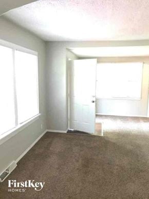 Aurora house for rent - an empty room with two windows and a door