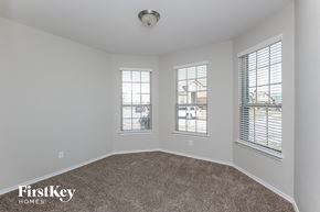 Haslet house for rent - the living room of a home with carpet and three windows
