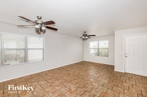 El Mirage house for rent - a living room with two ceiling fans and a window