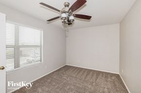 El Mirage house for rent - a bedroom with a ceiling fan and a window
