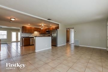 Seminole house for rent - A spacious kitchen with wooden cabinets and a tiled floor.