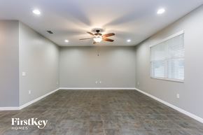 Riverview house for rent - the spacious living room has a ceiling fan and a large window