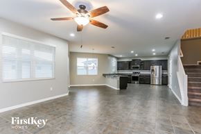 Riverview house for rent - an empty kitchen and living room with a ceiling fan