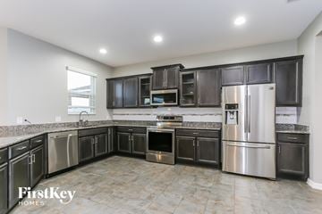 Riverview house for rent - a large kitchen with stainless steel appliances and black cabinets