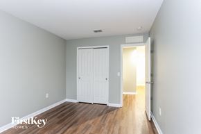 Riverview house for rent - a bedroom with a white door and wood floors