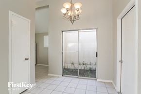 Houston house for rent - the entrance to the laundry room with a glass door and a chandelier