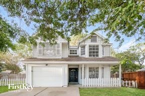 Houston house for rent - A two-story house with a white garage door and a black front door.