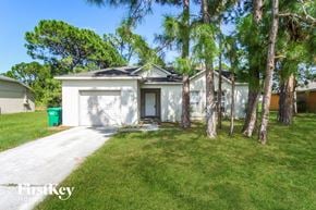 Sebastian house for rent - a small white house with palm trees in front of it