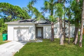 Sebastian house for rent - a white house with palm trees in front of it