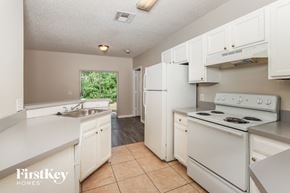 Sebastian house for rent - a kitchen with white appliances and white cabinets