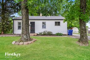 Florissant house for rent - A white house with a black door and a small porch.