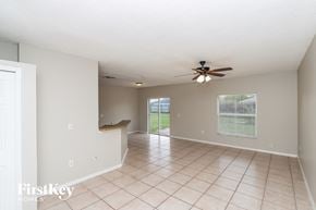 Sebastian house for rent - A spacious room with a ceiling fan and tiled floor.