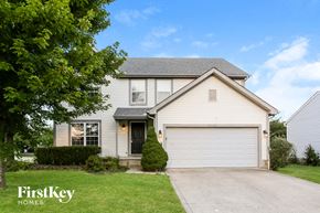 Blacklick house for rent - a white house with a driveway and a garage door