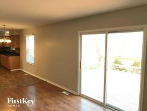 Blacklick house for rent - an empty living room with sliding glass doors to a patio