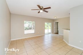 Sebastian house for rent - A spacious room with a ceiling fan and tiled flooring.