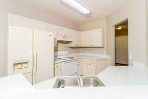 Sebastian house for rent - A kitchen with white appliances and cabinets.