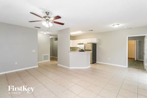 Sebastian house for rent - A spacious room with a fan and a counter in the middle.