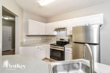 Sebastian house for rent - A kitchen with a stainless steel refrigerator and a sink.