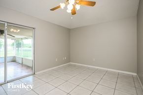 Kissimmee house for rent - a living room with a ceiling fan and a tiled floor