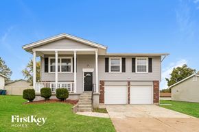 Black Jack house for rent - a beige house with a black door and a lawn