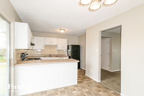 Black Jack house for rent - a kitchen with white cabinets and a black refrigerator
