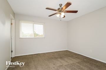 Black Jack house for rent - a living room with carpet and a ceiling fan