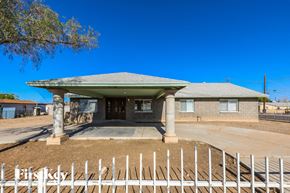 Peoria house for rent - A house with a white picket fence in front.