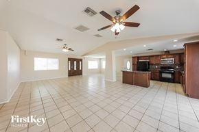 Peoria house for rent - A spacious living room with a kitchen in the background.
