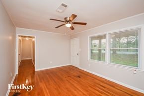 Covington house for rent - a living room with wood floors and a ceiling fan