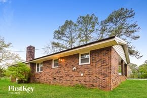 Covington house for rent - a brick house on a green lawn with trees