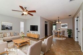 Orlando house for rent - A living room with a ceiling fan and a couch.