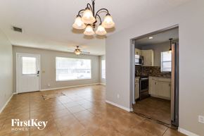Orlando house for rent - A spacious living room with a kitchen in the background.