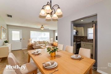 Orlando house for rent - A dining room with a wooden table set for a meal.