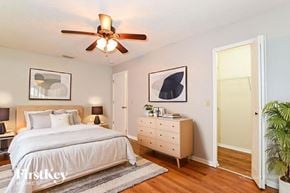 Orlando house for rent - A bedroom with a bed, dresser, and ceiling fan.