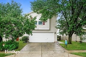 Greenwood house for rent - a white garage door in front of a white house