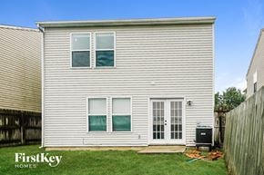 Greenwood house for rent - the outside of a white house with white siding and green grass