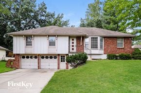 Kansas City house for rent - A brick house with a white garage door.