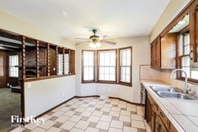 Kansas City house for rent - A kitchen with a tile floor and a ceiling fan.