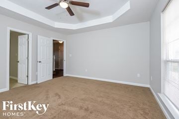 Alabaster house for rent - a living room with a carpet and a ceiling fan