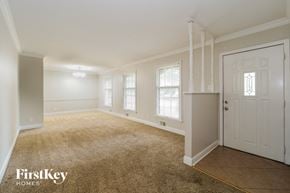 Kansas City house for rent - A room with a carpeted floor and a door on the right side.