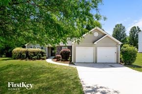 Lawrenceville house for rent - a home with a white driveway and a white garage door