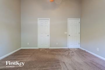 Lawrenceville house for rent - a living room with carpet and two doors