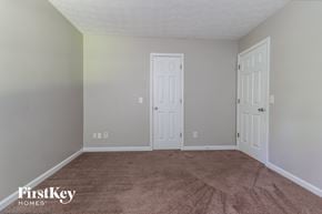 Lawrenceville house for rent - a bedroom with a carpeted floor and two doors